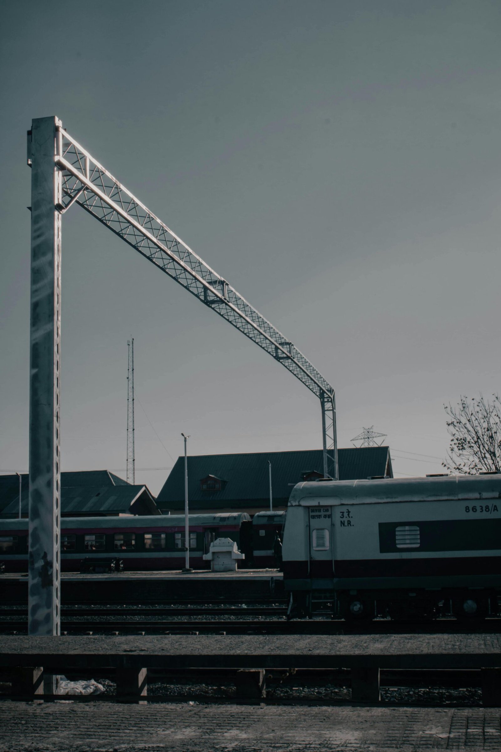 Serene view of a train and railway tracks at Mirgund station under a clear sky.